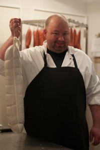 2013-march-april-1859-magazine-portland-oregon-farm-to-table-charcuterie-eric-finley-holding-sausage-for-curing