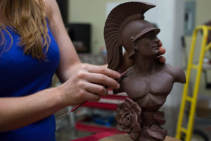 Allison Brown hands working clay of USC Trojan