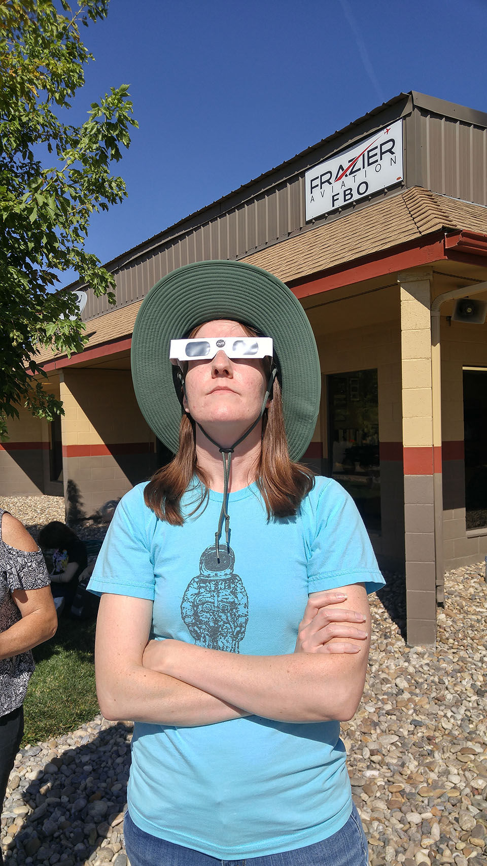 My wife safely watching the eclipse with her eclipse glasses.