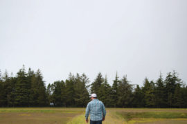 Whit Peters walks between cranberry bogs at Peters’ Cranberries in Sixes.