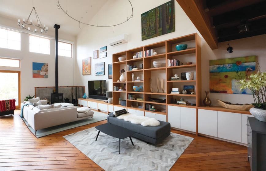 With an aesthetic gained from having lived in Norway between high school and college, the owner installed an exposed loft built from salvaged beams from her partner’s shipyard.