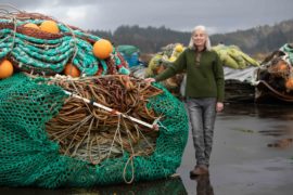 Sarah Skamser stands among nets used by fishing vessels, including those made by Foulweather Trawl, at the Newport International Terminal on Nov. 25 in Newport, Oregon.