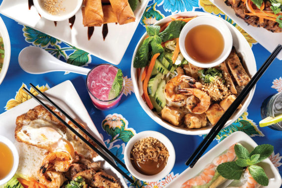At Fish Sauce, send your palate on a trip with, clockwise from top left, chuối chiên; pork bánh mì; bún vermicelli; gỏi cuốn; Botta’s Favorite with grilled shrimp, fried egg, jasmine rice and núớc mắm; and the Fortune & Glory cocktail with rum, mint, hibiscus and lime.