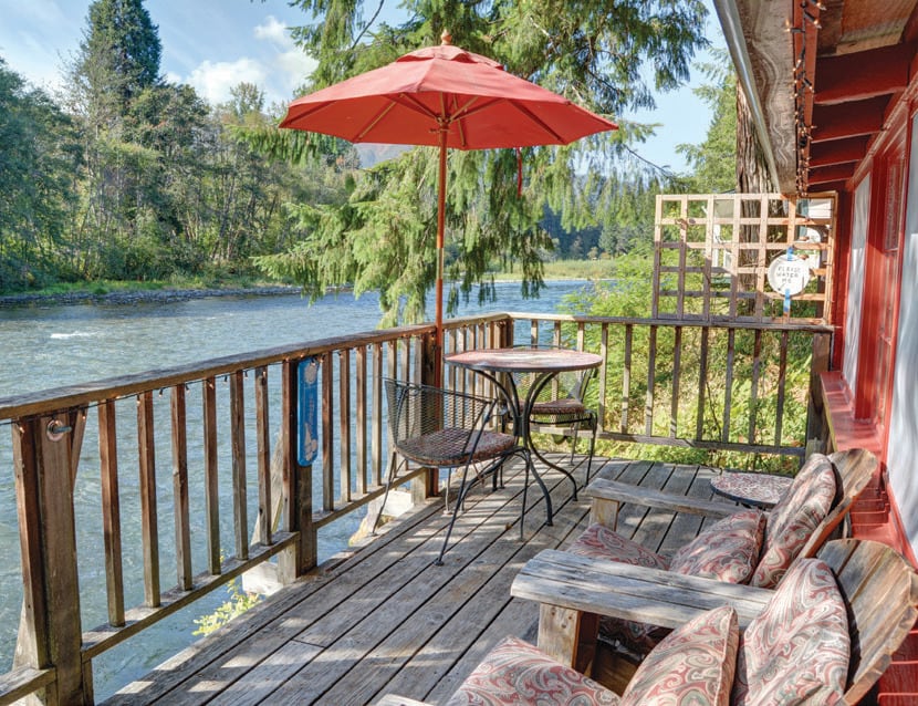 McKenzie River Lookout Cottage offers an old-school forest getaway ambiance with river views from the king bed by the fireplace.
