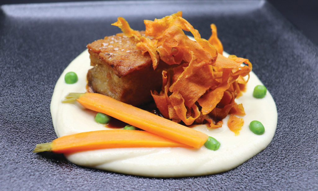 Restaurant O’s crispy pork belly with carrot crisps, apple-celery purée and five-spice jus.