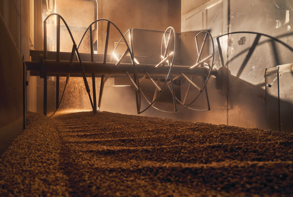 Fresh barley enters the malter where it is raked, forming patterns, then sprayed with water before continuing its journey through the malting process.