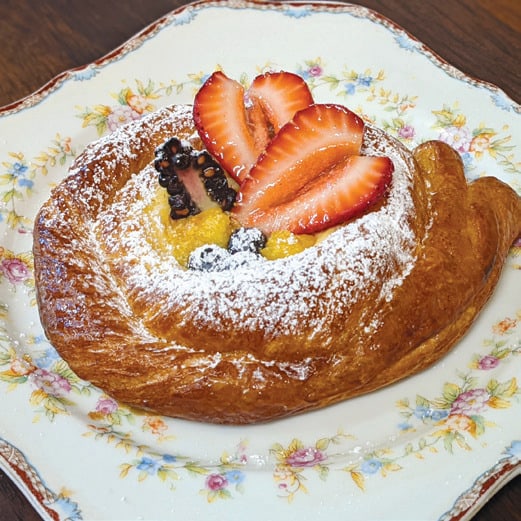 Bread & Roses Bakery’s “Celestial Snail”—its version of a cheese danish, with lemon curd, fresh fruit and a dusting of powdered sugar.