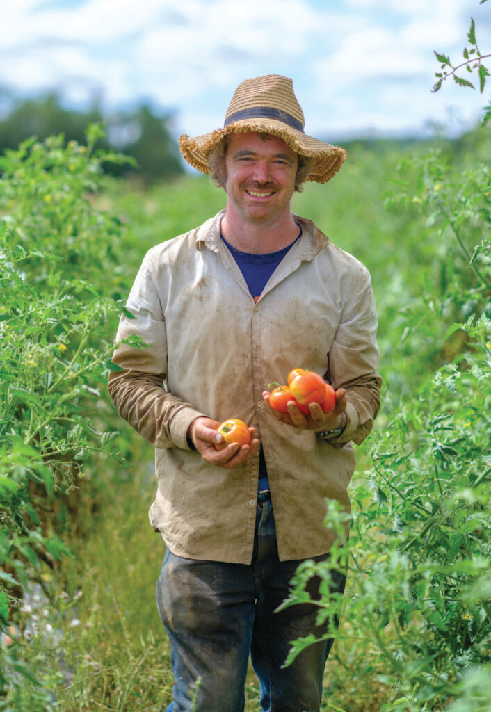 Farmer and chef Aaron Nichols with a few of the tomato varieties grown at Stoneboat Farm.