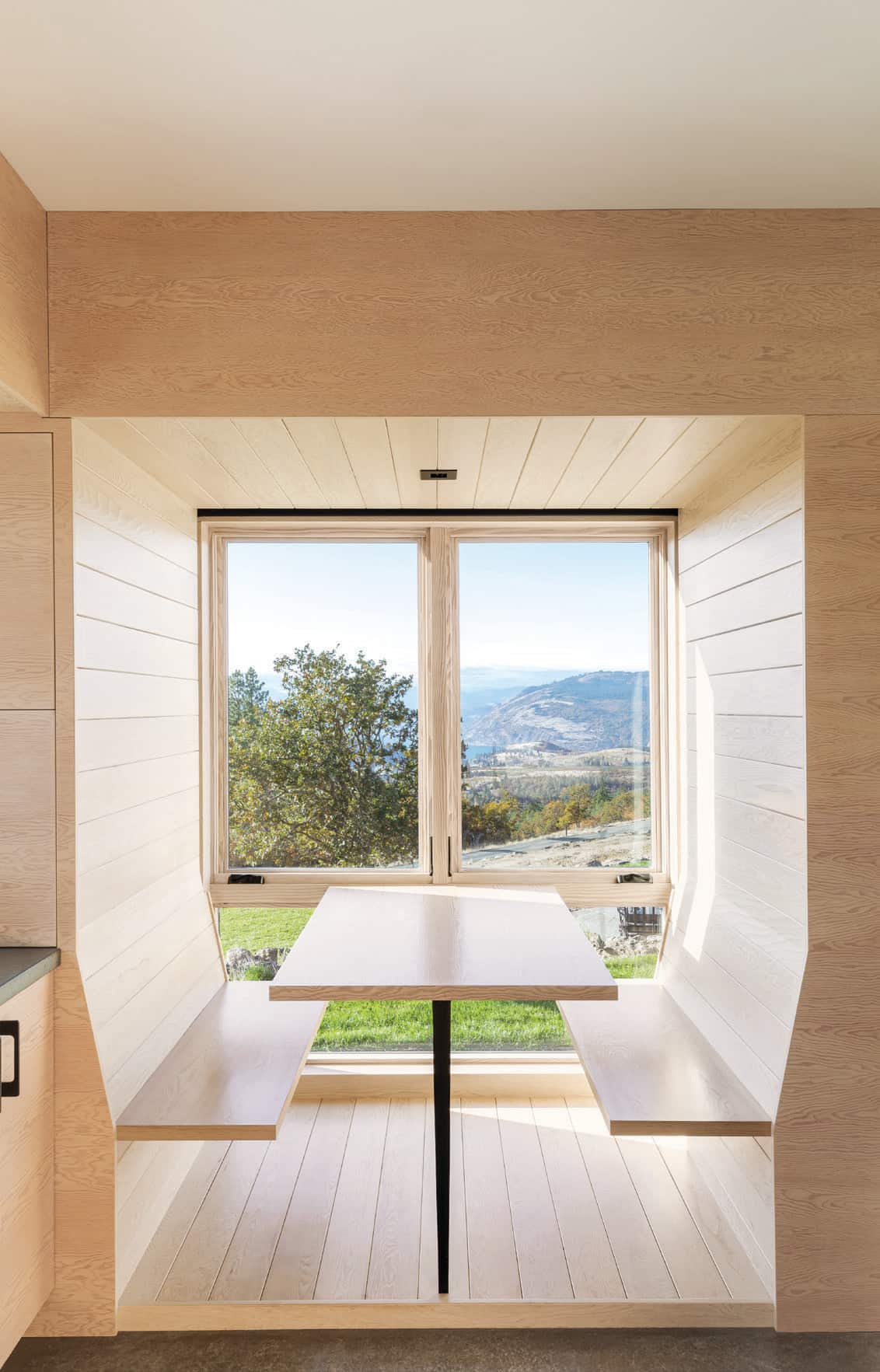 The kitchen nook with floating benches and sweeping views makes for intriguing meals.