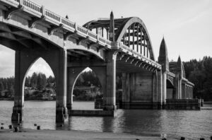 The Siuslaw River Bridge’s tied arches, identical to those designed for Alsea Bay and the Umpqua River bridges, have their roots in the Wilson River Bridge.