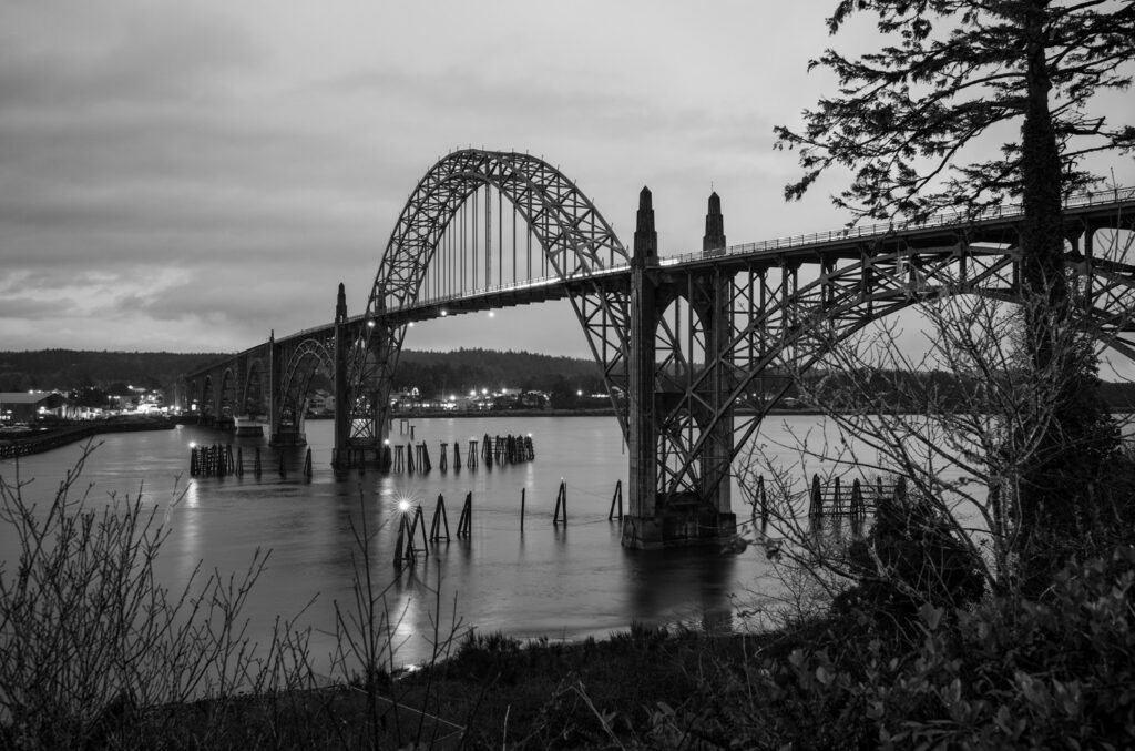 Views of the Yaquina Bay Bridge define the skyline and identity of Newport, night and day.
