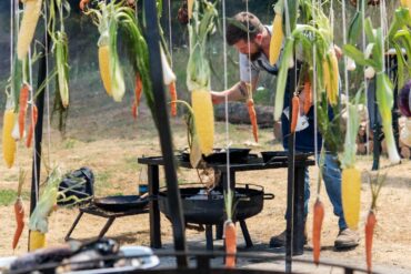 Meat and vegetables hang from a fire dome during Tournant’s recent Oregon Asado event near Dundee.