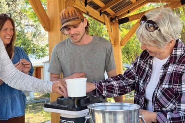 Rockhound Bailey Lefever (center) teaches a jewelry-making class in Spray.